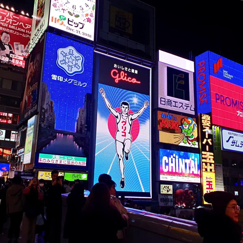 1-day osaka itinerary - a picture of Glico Man and other large neon-lit billboards at Dotonbori