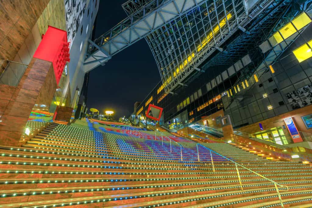 kyoto station at night - the station is fully lit up with different colours at night