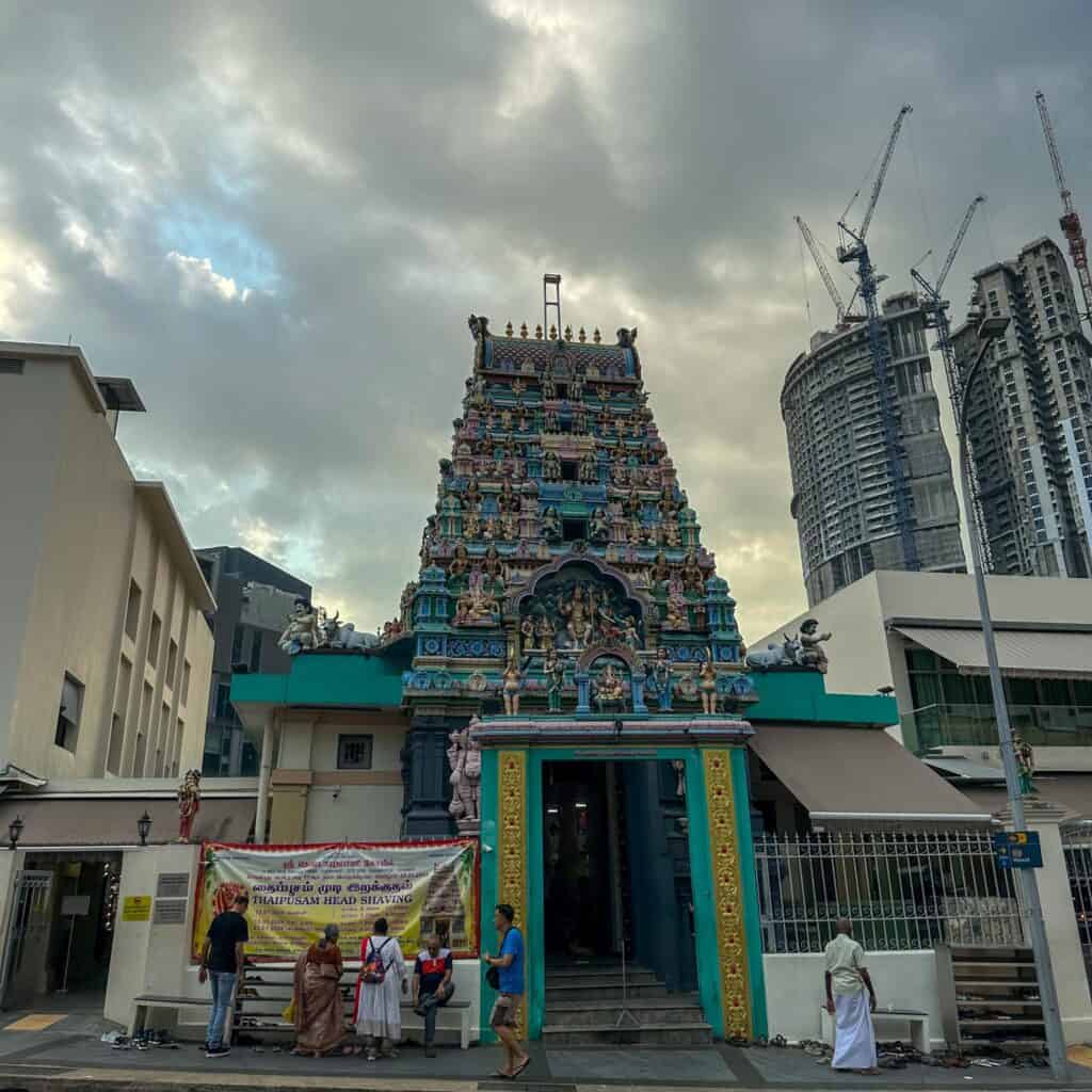 do and don't in Singapore - several devotees are removing their shoes before entering the temple compound near Chinatown Singapore.