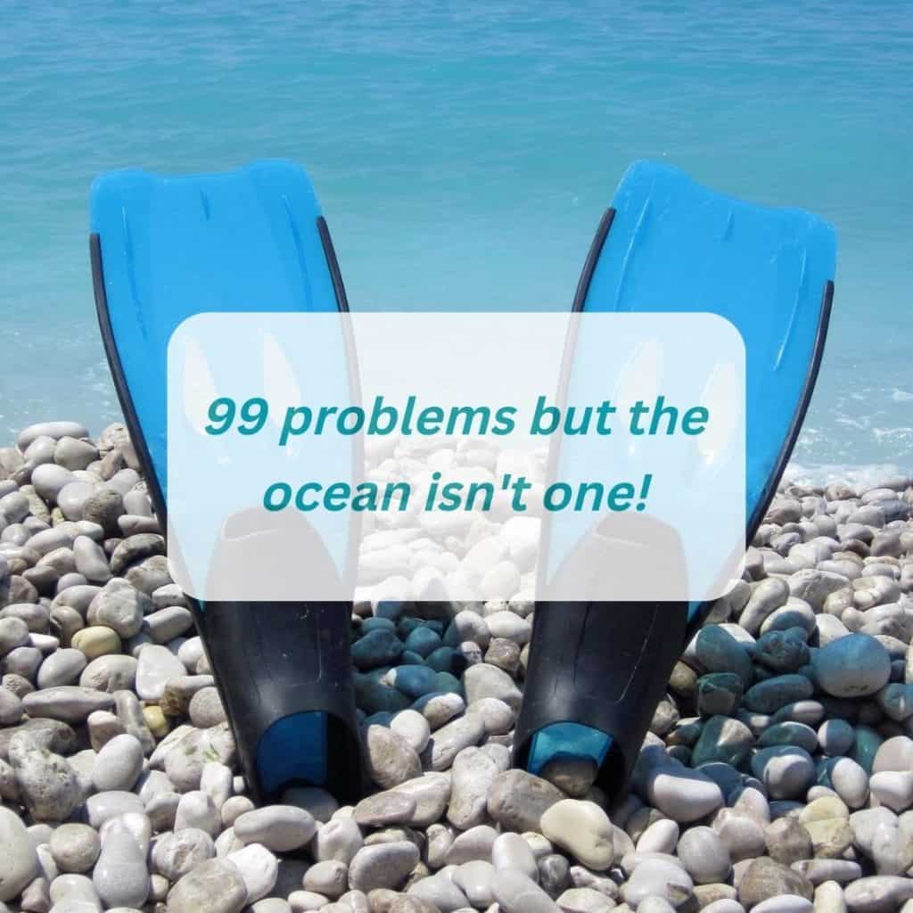 funny scuba diving captions - blue diving fins on the rock beach next to the sea