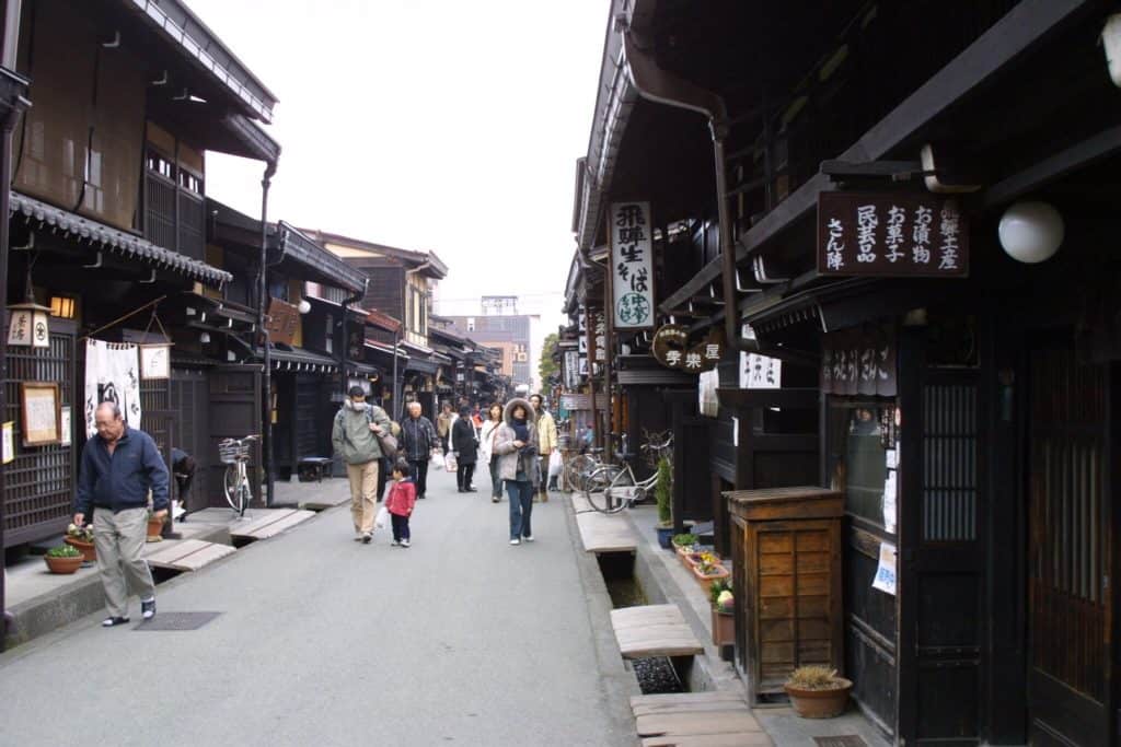 takayama old town winter - visitors walking down the streets in Takayama Old Town