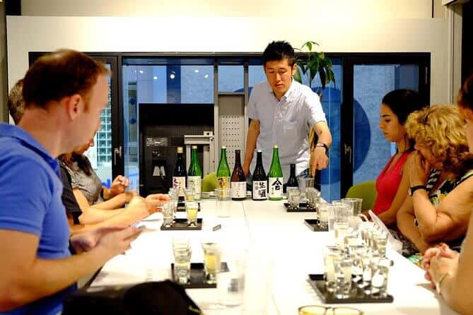 food tour in kyoto - the sake expert explaining the different types of sake to the participants