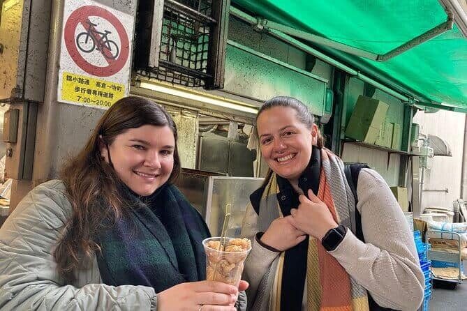 food tour kyoto - two ladies posing with the takoyaki