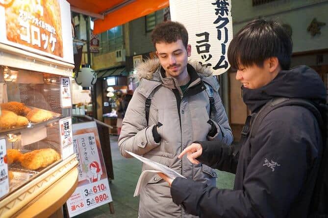 food tours in kyoto  - a tourist talking to the guide about the food menu