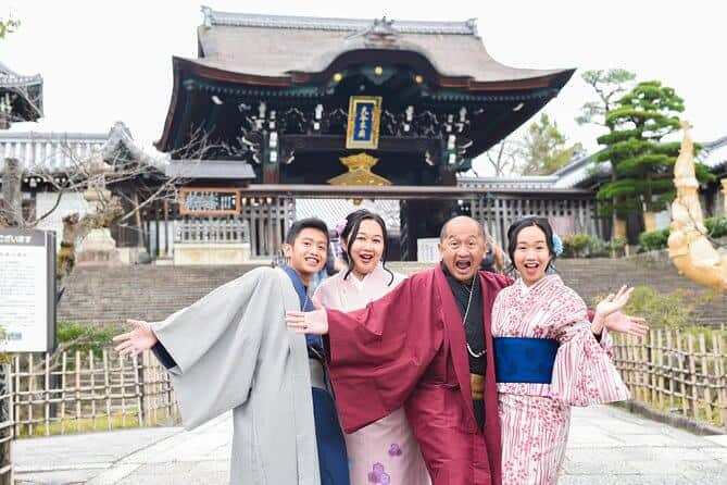 kyoto photography tours 5 - a family of 4 donning in kimono posing in front of the Kyoto landmark