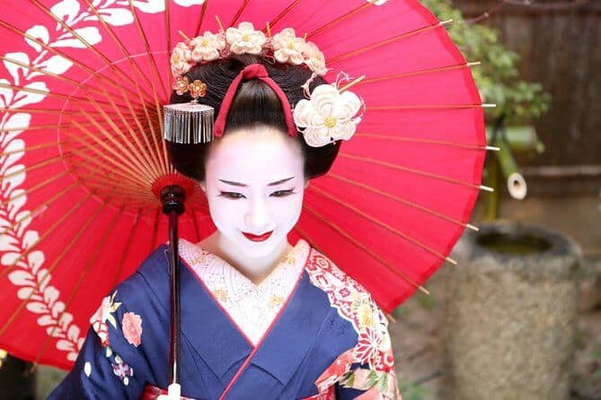 kyoto photography tours 7 - a lady dressed as a Maiko holding a red wooden umbrella