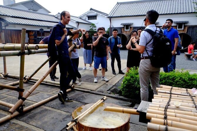 KYOTO SAKE BREWERY - the English-speaking guide is explaining about sake history to the participants at the sake brewery during the 3 Hours Kyoto Insider Sake Experience