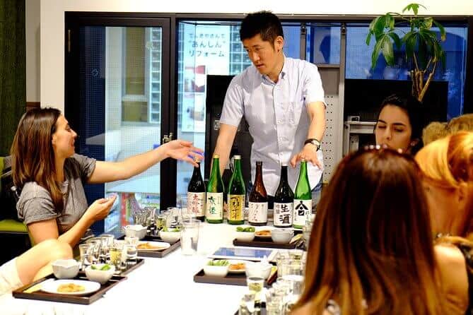 KYOTO SAKE TOUR - THE SOMMELIER IS ANSWERING THE QUESTIONS THAT THE PARTICIPANT HAS ABOUT JAPANESE SAKE