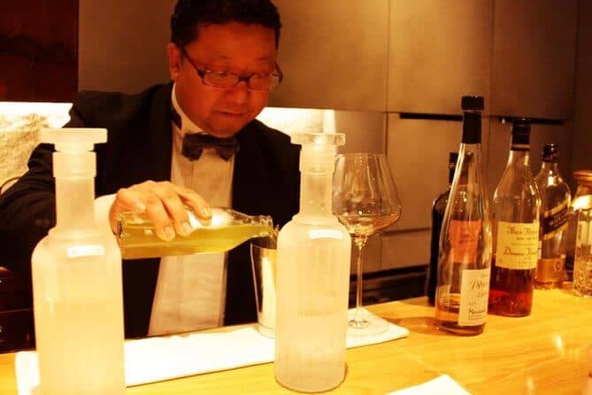 Kyoto sake tour - the bartender is preparing the cocktail at the hidden bar in this Kyoto sake tour