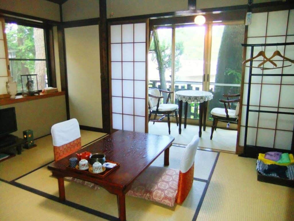 best ryokan with private onsen in takayama - room with tatami flooring and 2 low seats in Sumiyoshi 