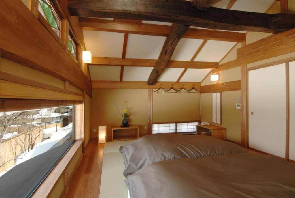 onsen in takayama - a room with 2 futon beds and with a snowy view overlooking the compound at Katsuragi no Sato
