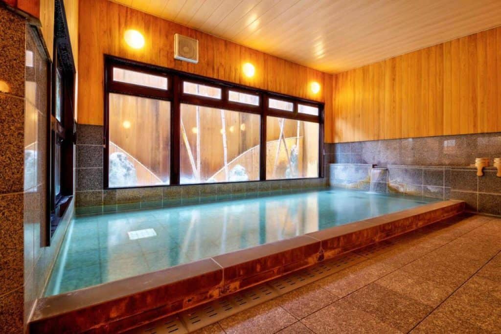 ryokan with private onsen takayama - hot spring bath in Oyado Koto No Yume