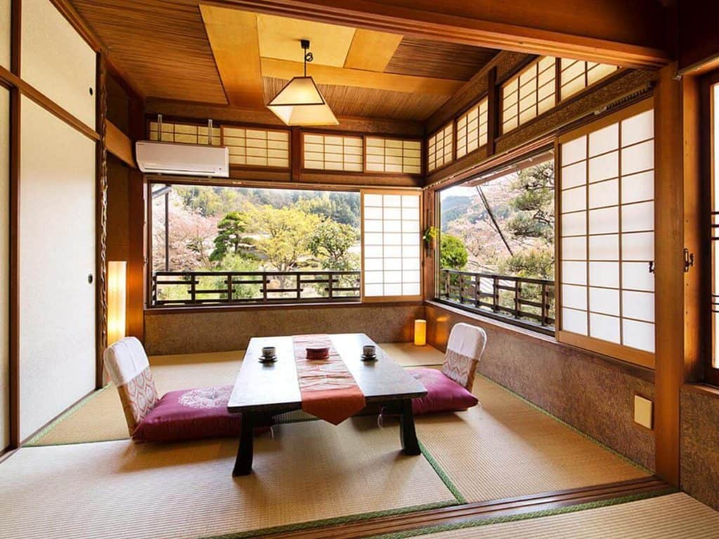 ryokan in osaka with private onsen - the seating area in one of the rooms at Nanten-En surrounded with lush greenery