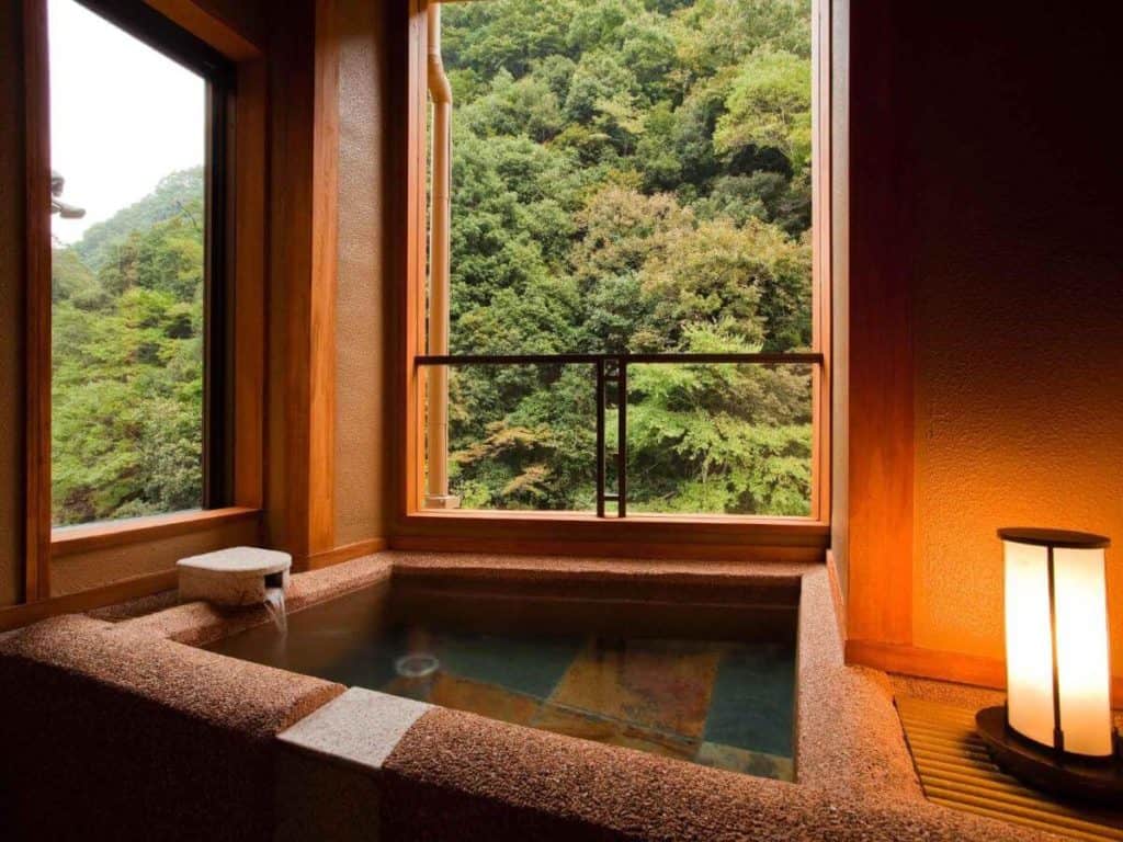 ryokan osaka private onsen - the private open-air bath overlooking the lush greenery at Hananosato Onsen Sansuikan