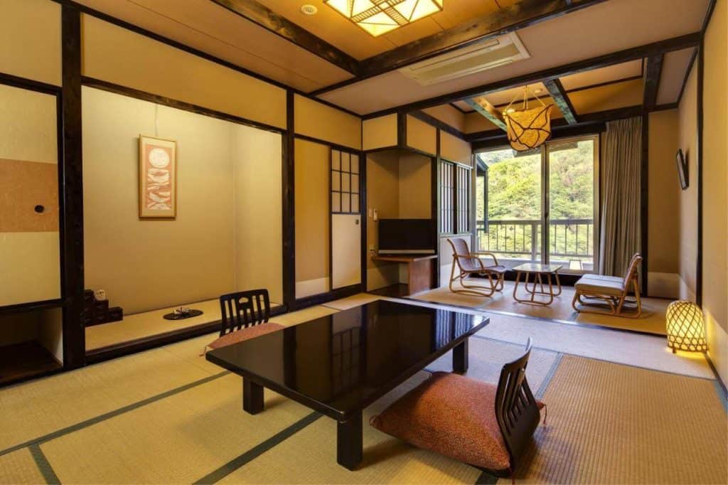 ryokan with private onsen in osaka - the low seating area with table in one of the rooms at Ryokan Fushioukaku