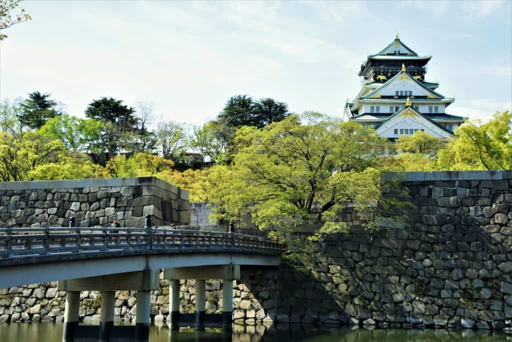 is osaka safe - a bridge above the moat with Osaka Castle as the backdrop