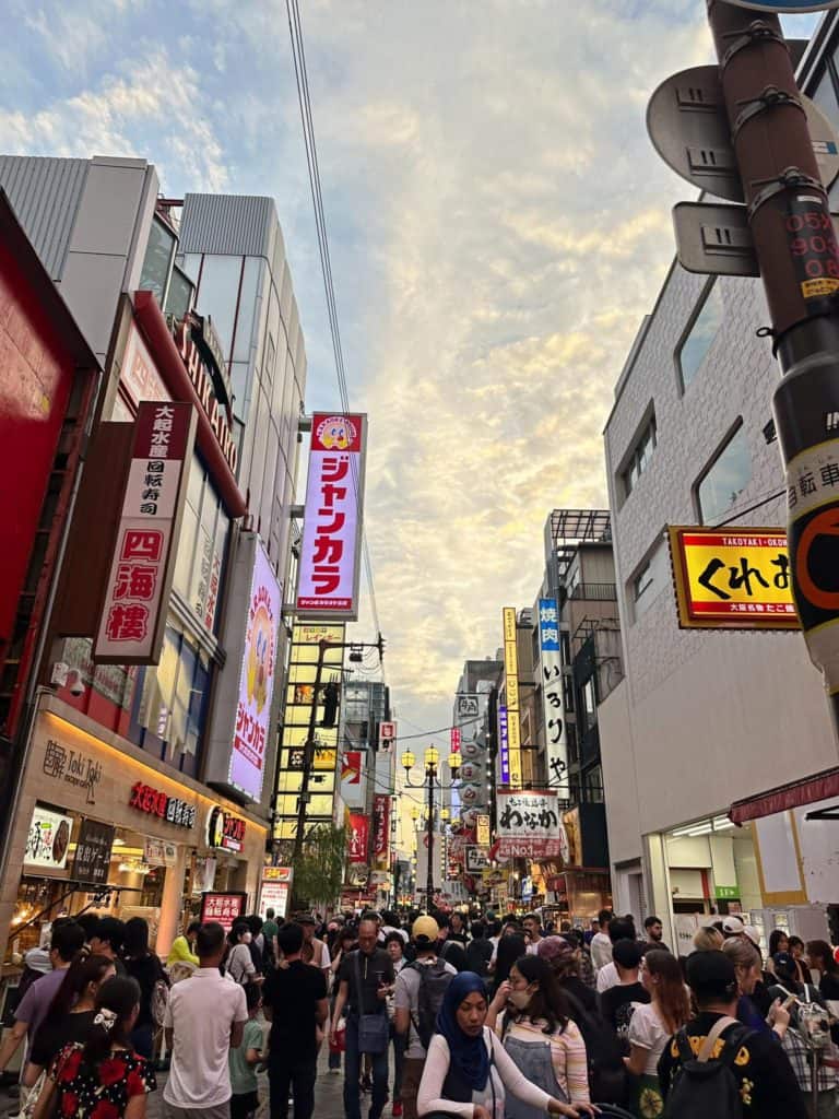is osaka safe at night - bustling street filled with people at Dotonbori in Osaka during sunset