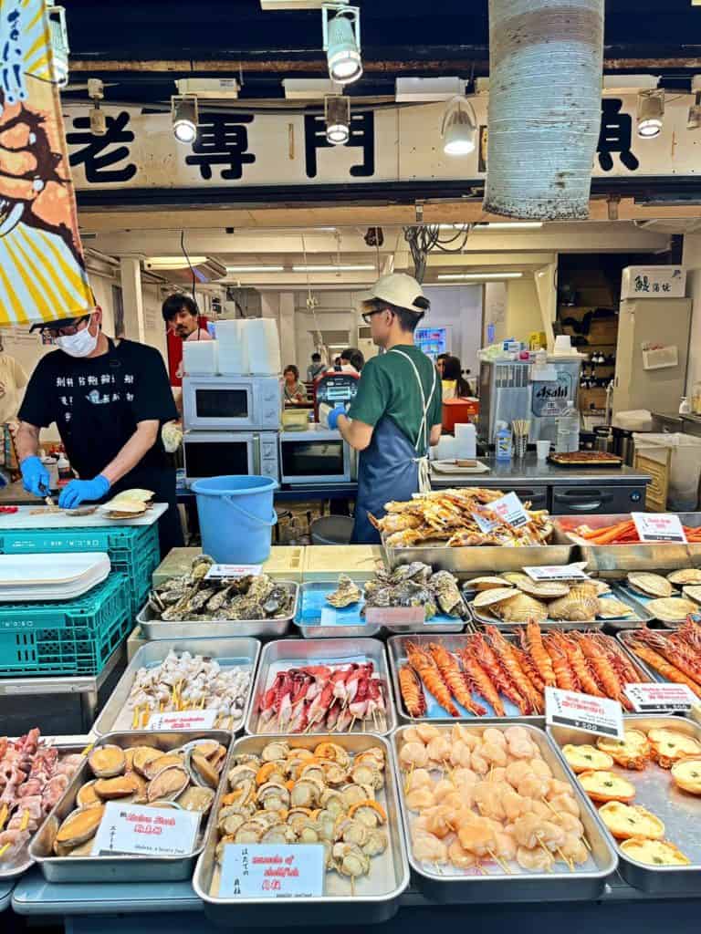 is osaka safe to travel alone - a variety of fresh seafood sold at Kuromon Market in Osaka 