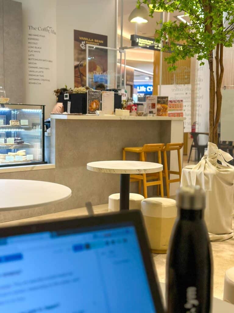 things to do alone in singapore - working on laptop in a coffee shop at Novena Singapore