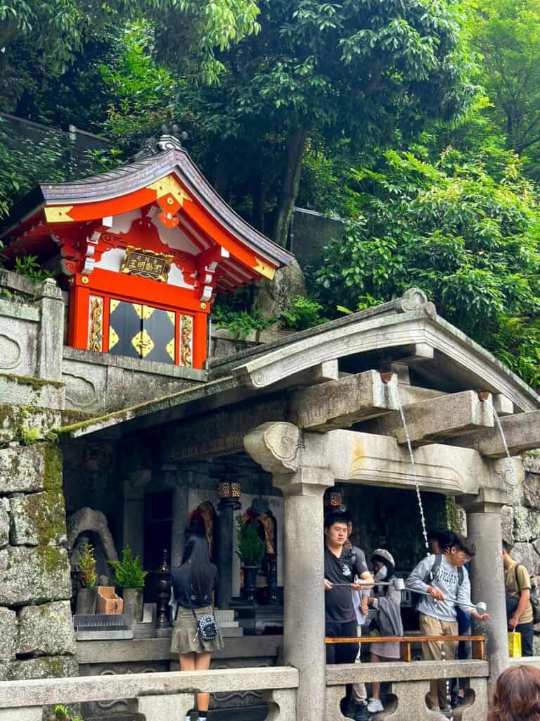 Kyoto Instagrammable Place - visitors are queuing to drink the water streams at Otowa Waterfall at Kiyomizudera Temple