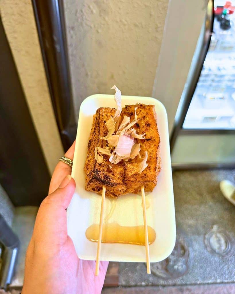 Kyoto 3 day itinerary - me holding a plate of grilled Kyoto tofu