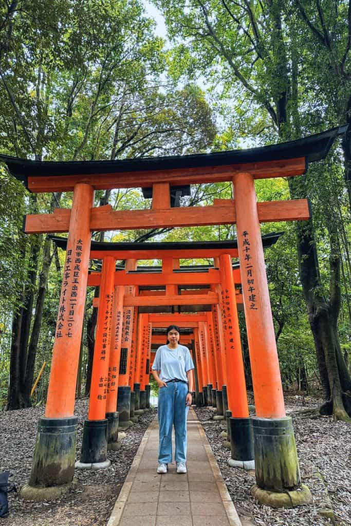 best hotels in Kyoto - me standing in front of the torii gates at Fushimi Inari Shrine Kyoto