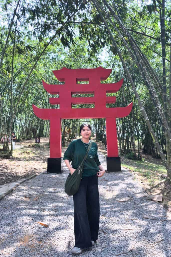 me standing in front of a torii-shaped structure surrounded by bamboo shoots