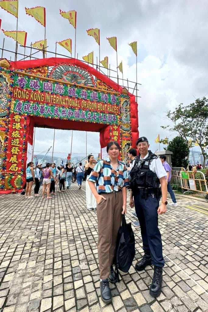 Sam Lee Travel - mea taking a photo with a police officer during the dragon boat competition at Hong Kong