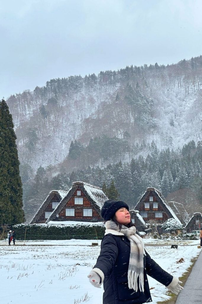 Sam Lee Travel - me posing in front of the 3 Houses at Shirakawa-go in winter